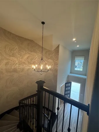 a view of a hallway with a chandelier