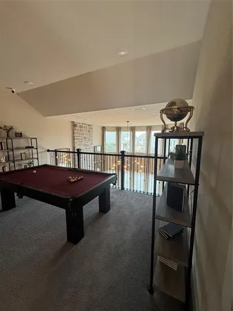 a living room with furniture a rug and a floor to ceiling window