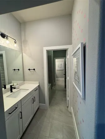 a spacious bathroom with a double vanity sink and a mirror