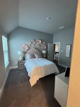 a bedroom with a bed and window