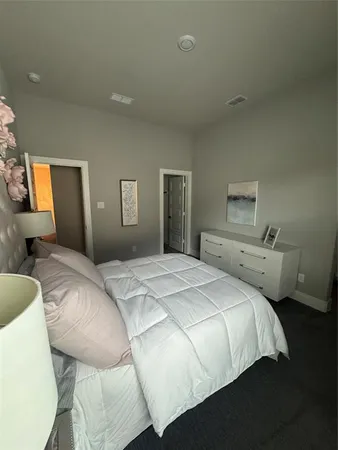 a bedroom with a bed and a dresser