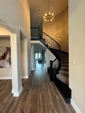 a view of entryway and hall with wooden floor