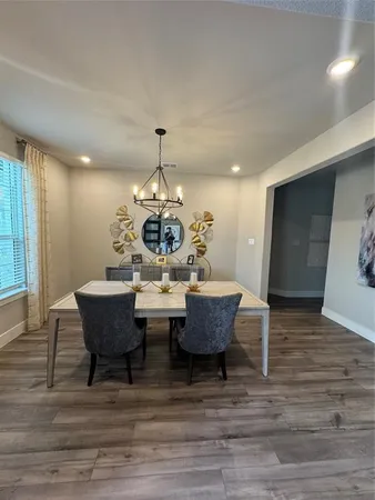 a view of a dining room with furniture and wooden floor
