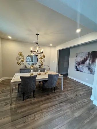 a view of a dining room with furniture wooden floor and a chandelier