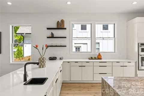 a kitchen with kitchen island granite countertop a sink and a counter top space