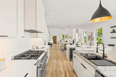 a large white kitchen with a large window