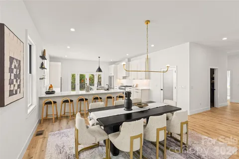 a kitchen with a sink and chairs