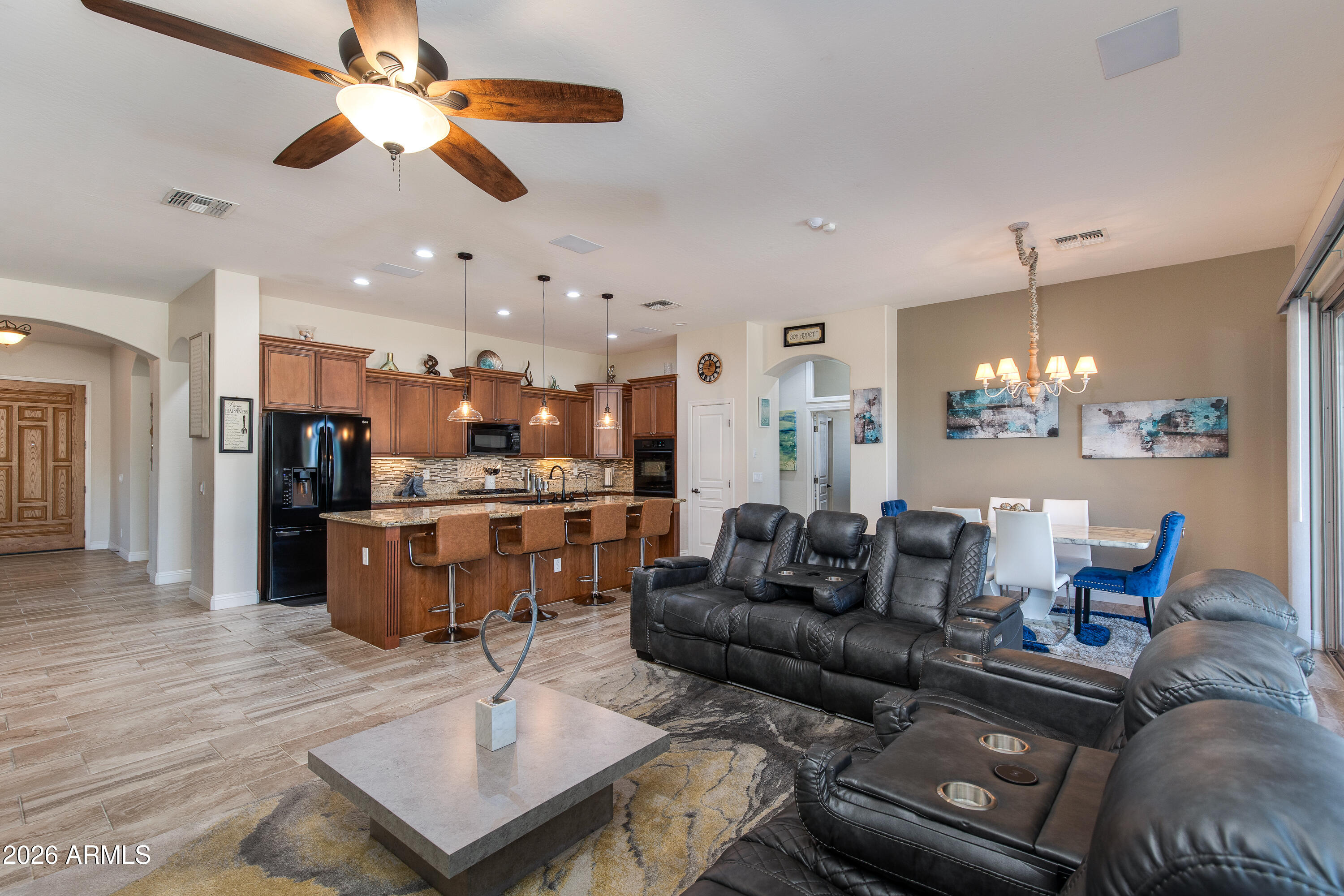 7718 North 84th Lane Glendale, AZ 85305 - Photo 10 of 82 a living room with furniture kitchen view and a chandelier