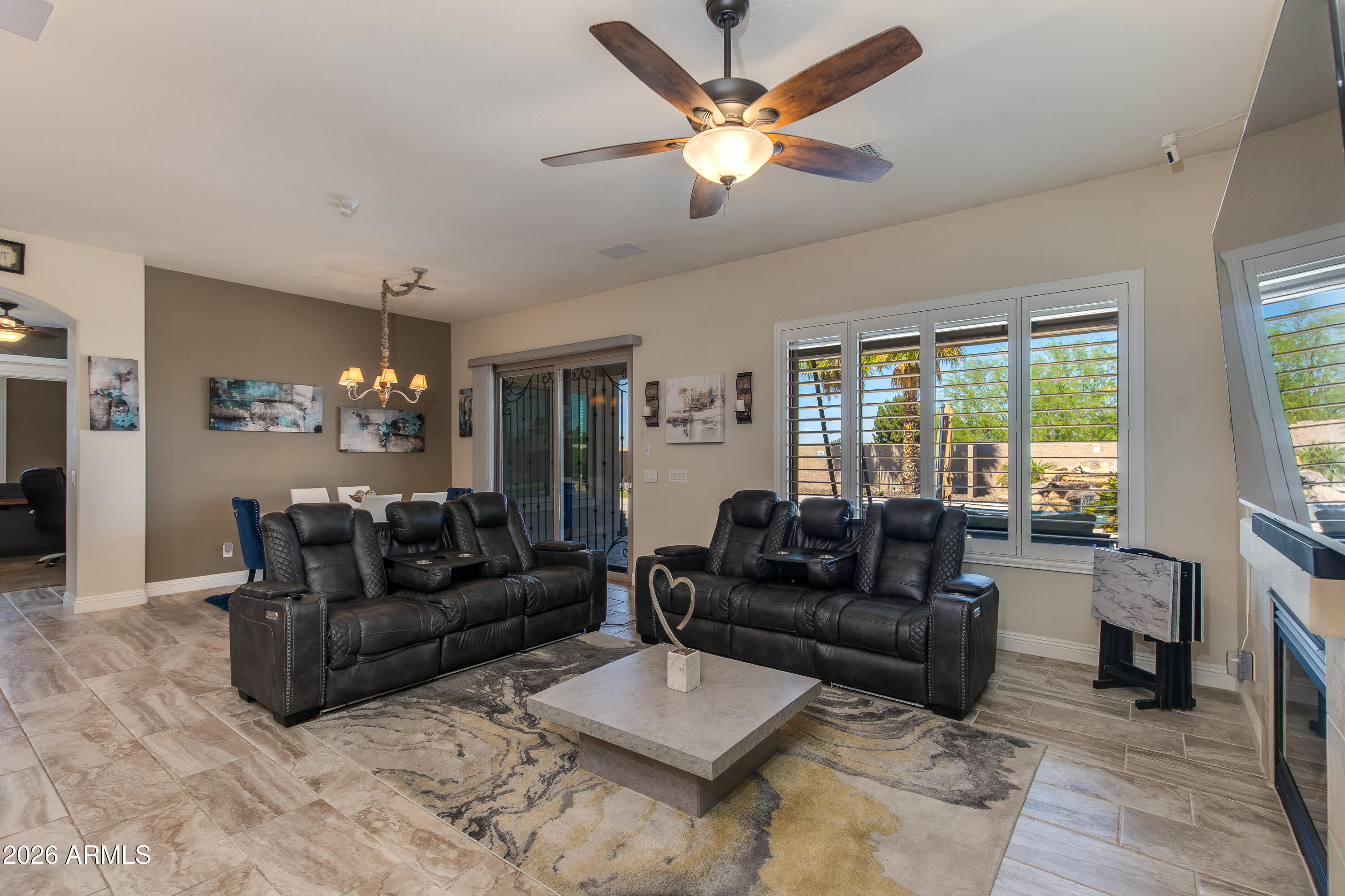 7718 North 84th Lane Glendale, AZ 85305 - Photo 14 of 82 a living room with furniture ceiling fan and a large window