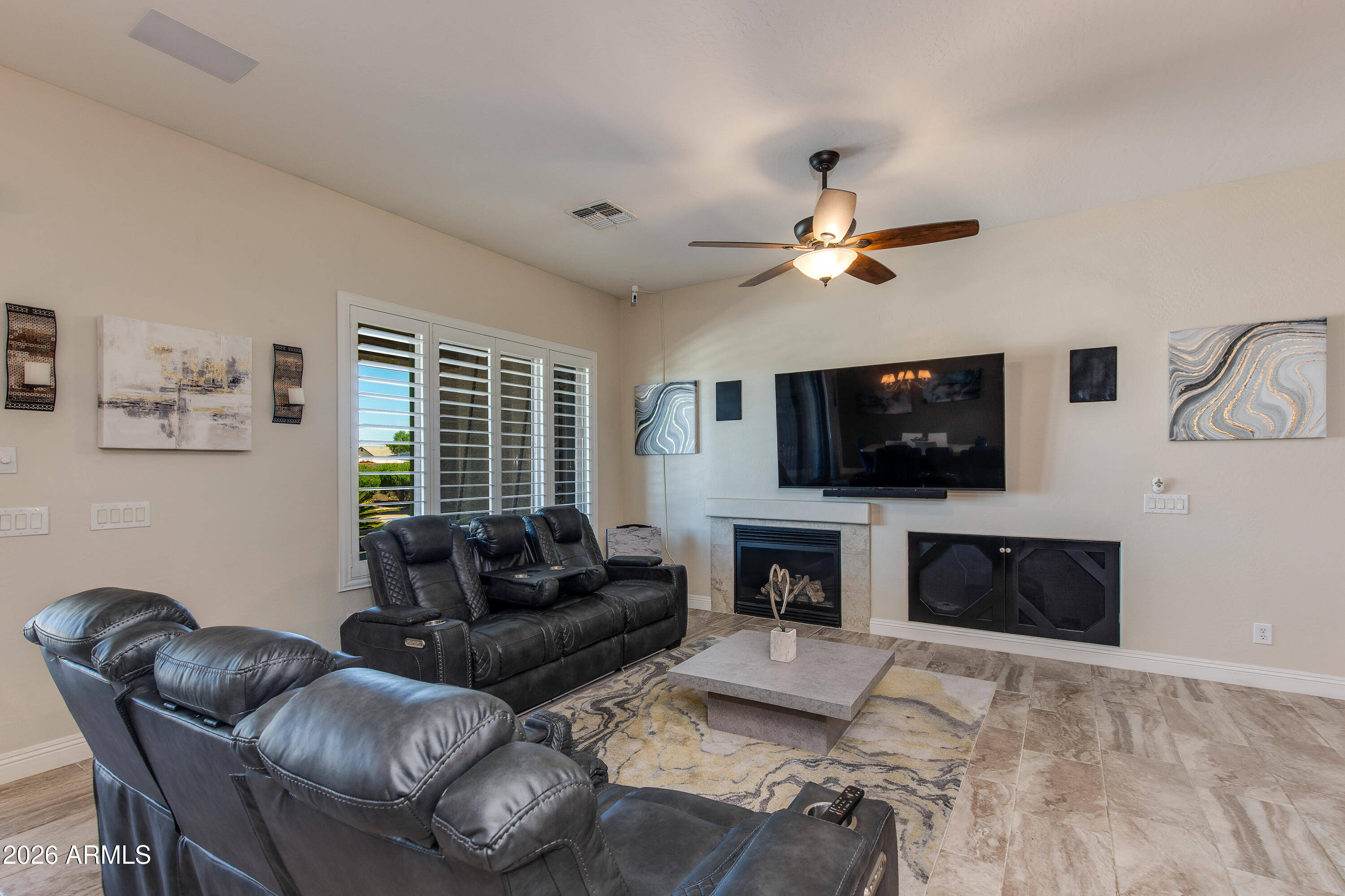 7718 North 84th Lane Glendale, AZ 85305 - Photo 15 of 82 a living room with furniture a flat screen tv and a fireplace