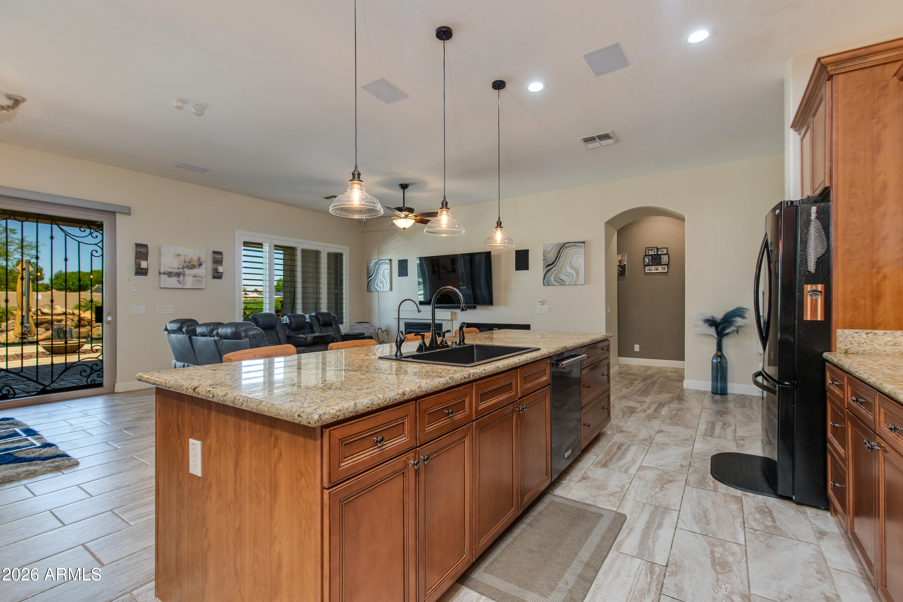 7718 North 84th Lane Glendale, AZ 85305 - Photo 18 of 82 a kitchen with stainless steel appliances granite countertop sink stove top oven and refrigerator