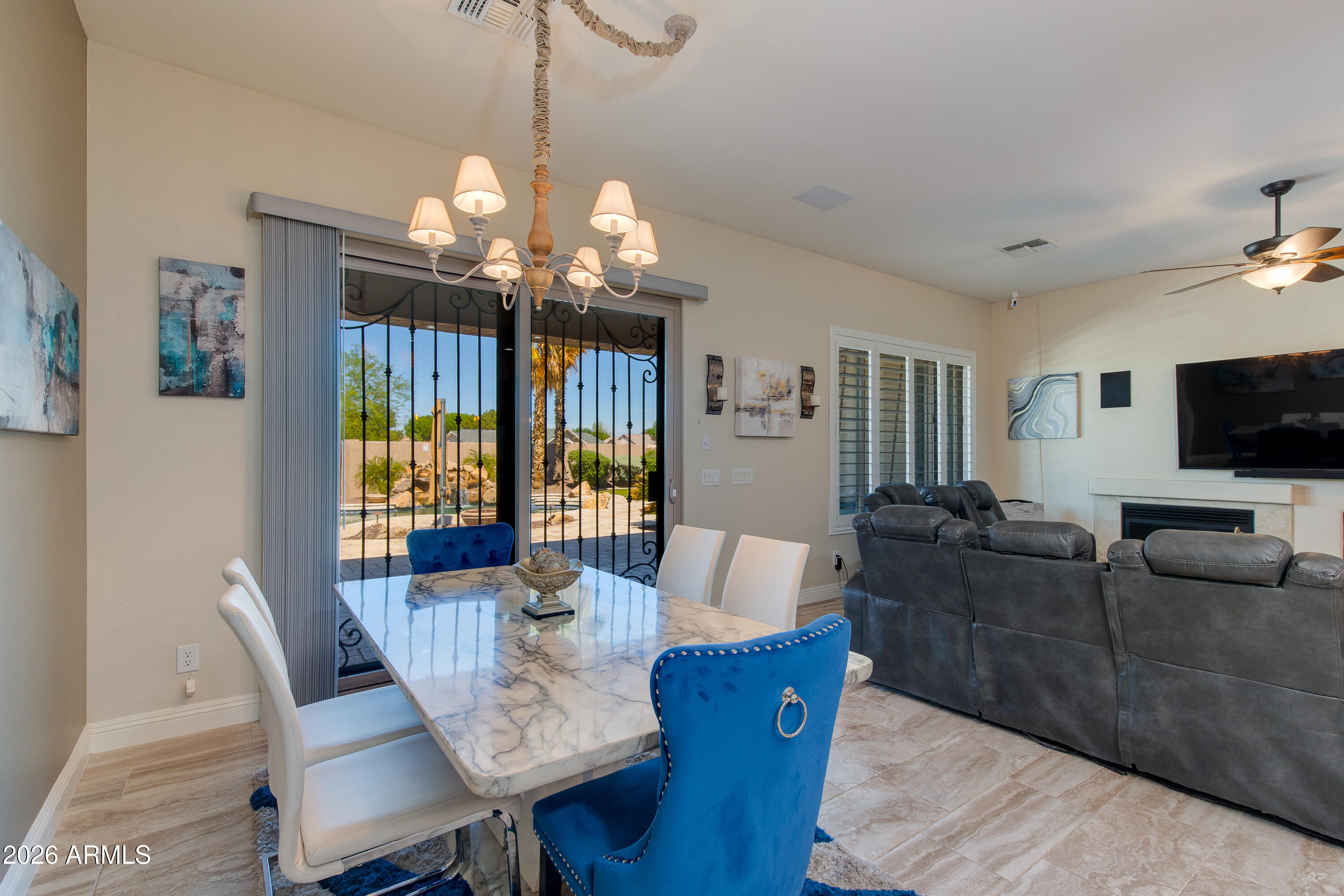 7718 North 84th Lane Glendale, AZ 85305 - Photo 20 of 82 a view of a dining room with furniture a chandelier and wooden floor