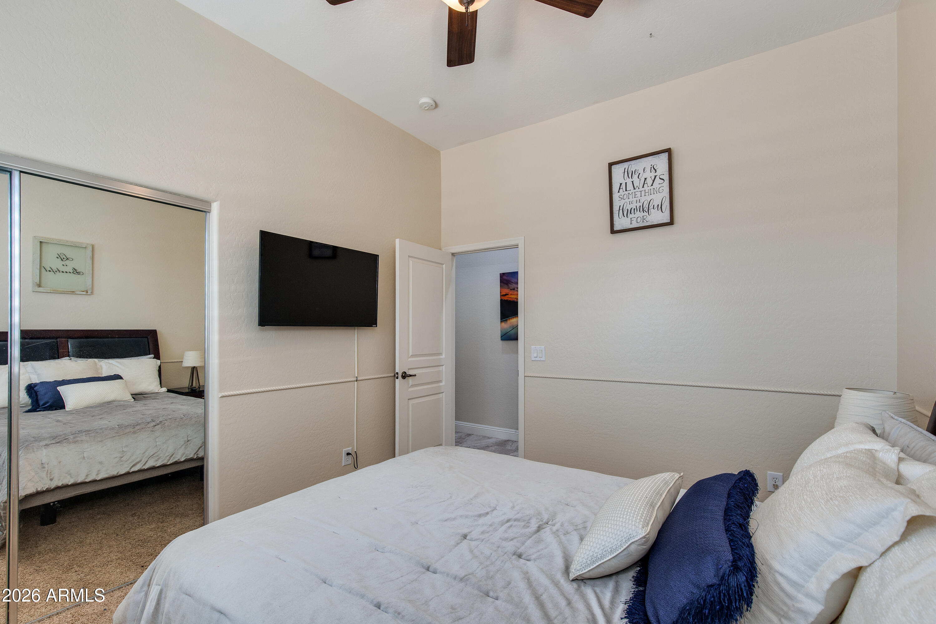 7718 North 84th Lane Glendale, AZ 85305 - Photo 28 of 82 a bedroom with a bed and a flat screen tv