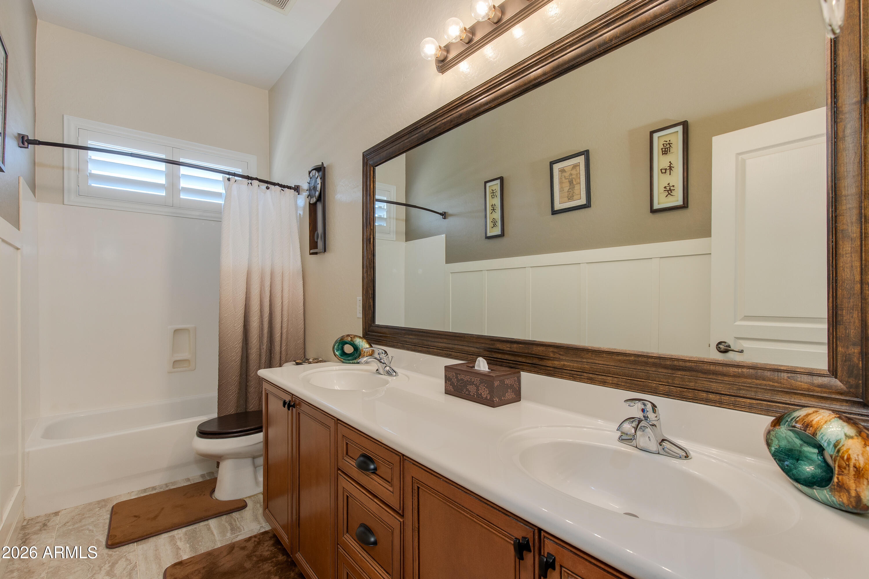 7718 North 84th Lane Glendale, AZ 85305 - Photo 32 of 82 a bathroom with a double vanity sink toilet mirror and shower