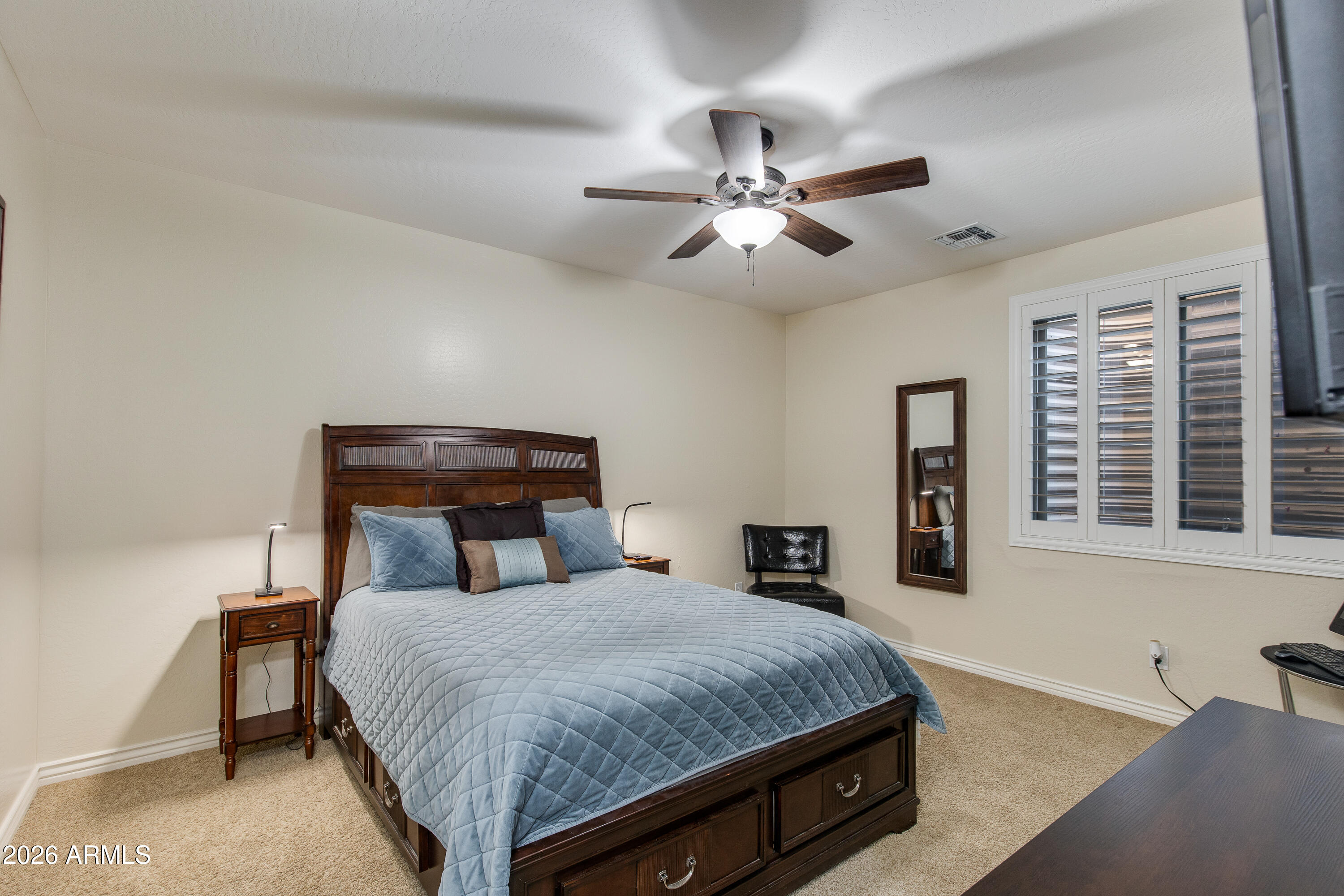 7718 North 84th Lane Glendale, AZ 85305 - Photo 45 of 82 a bedroom with a large bed and a chandelier