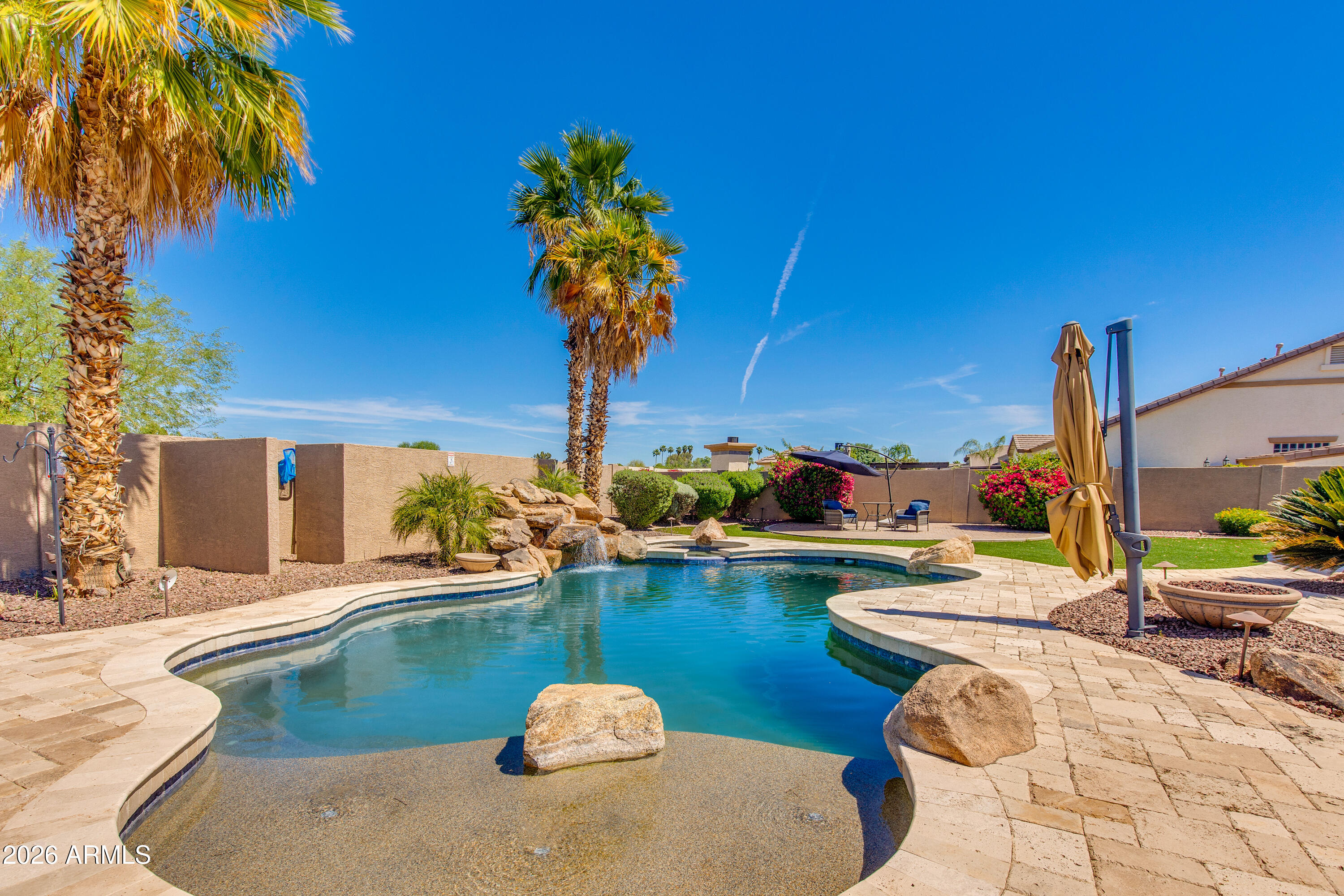 7718 North 84th Lane Glendale, AZ 85305 - Photo 50 of 82 a view of a swimming pool with a patio and a fire pit