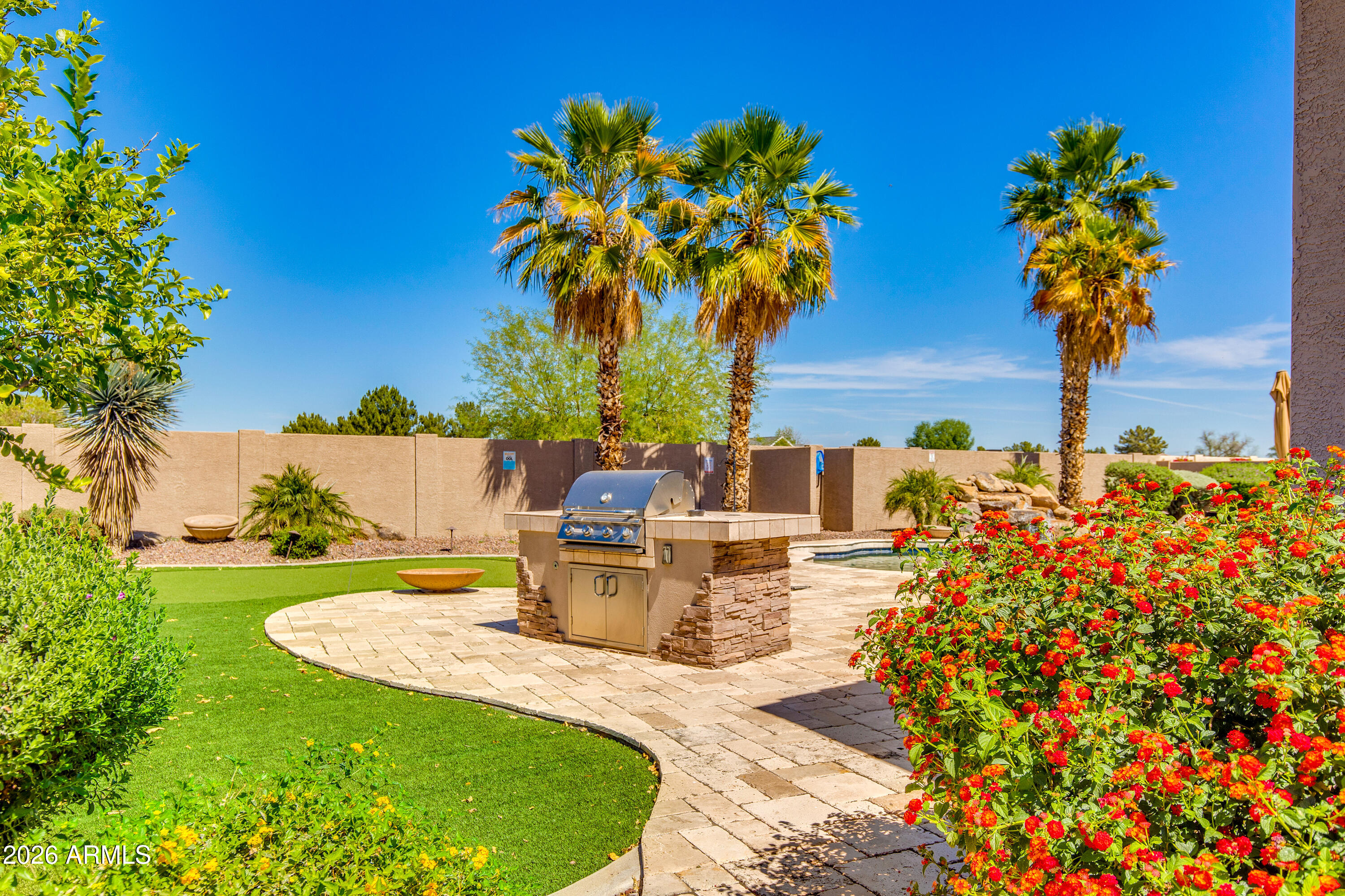 7718 North 84th Lane Glendale, AZ 85305 - Photo 56 of 82 a view of a swimming pool with a table and chairs