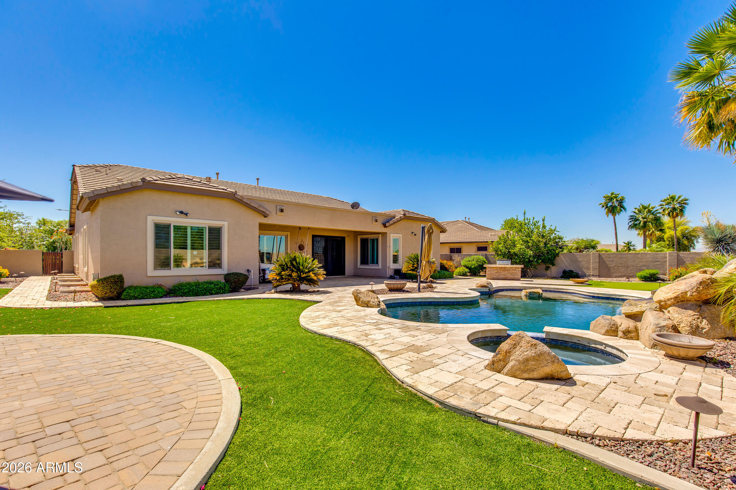 7718 North 84th Lane Glendale, AZ 85305 - Photo 59 of 82 a view of a house with backyard swimming pool and sitting area