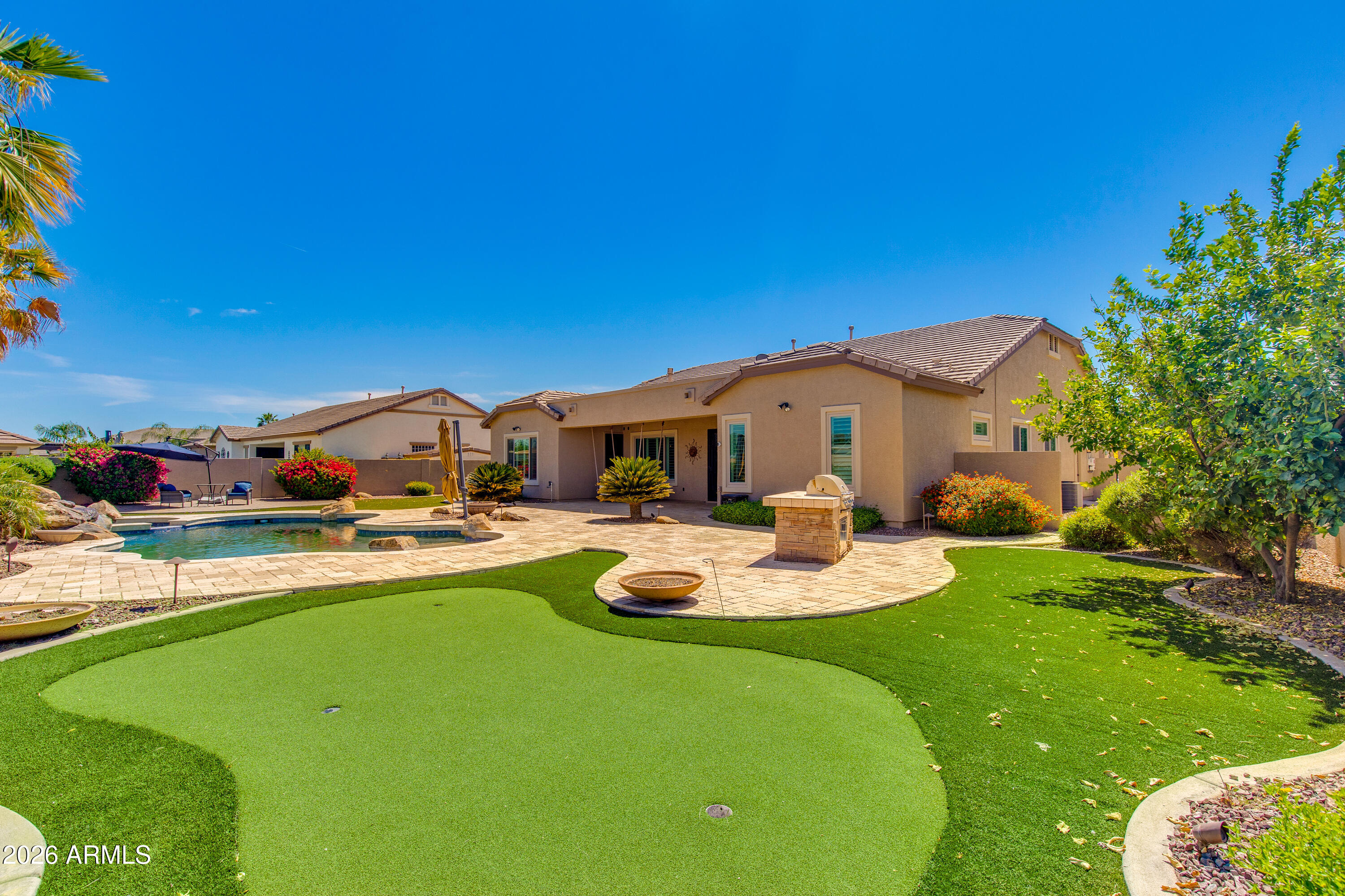 7718 North 84th Lane Glendale, AZ 85305 - Photo 61 of 82 a backyard of a house with table and chairs