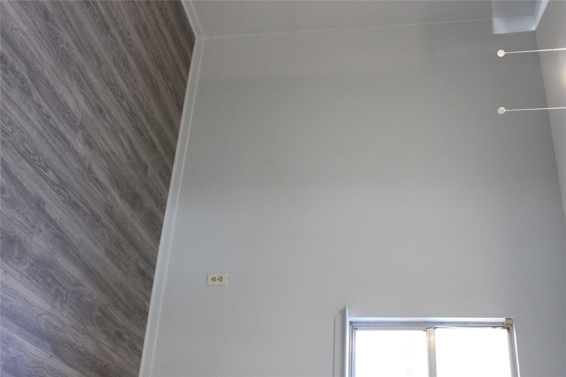 3300 Fritz Hughes Park Road Austin, TX 78732 - Photo 11 of 25 a view of an empty room with wooden floor and a window