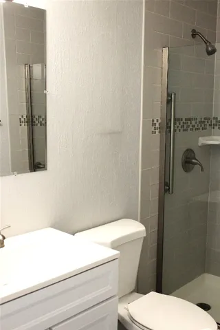 a bathroom with a toilet and a shower
