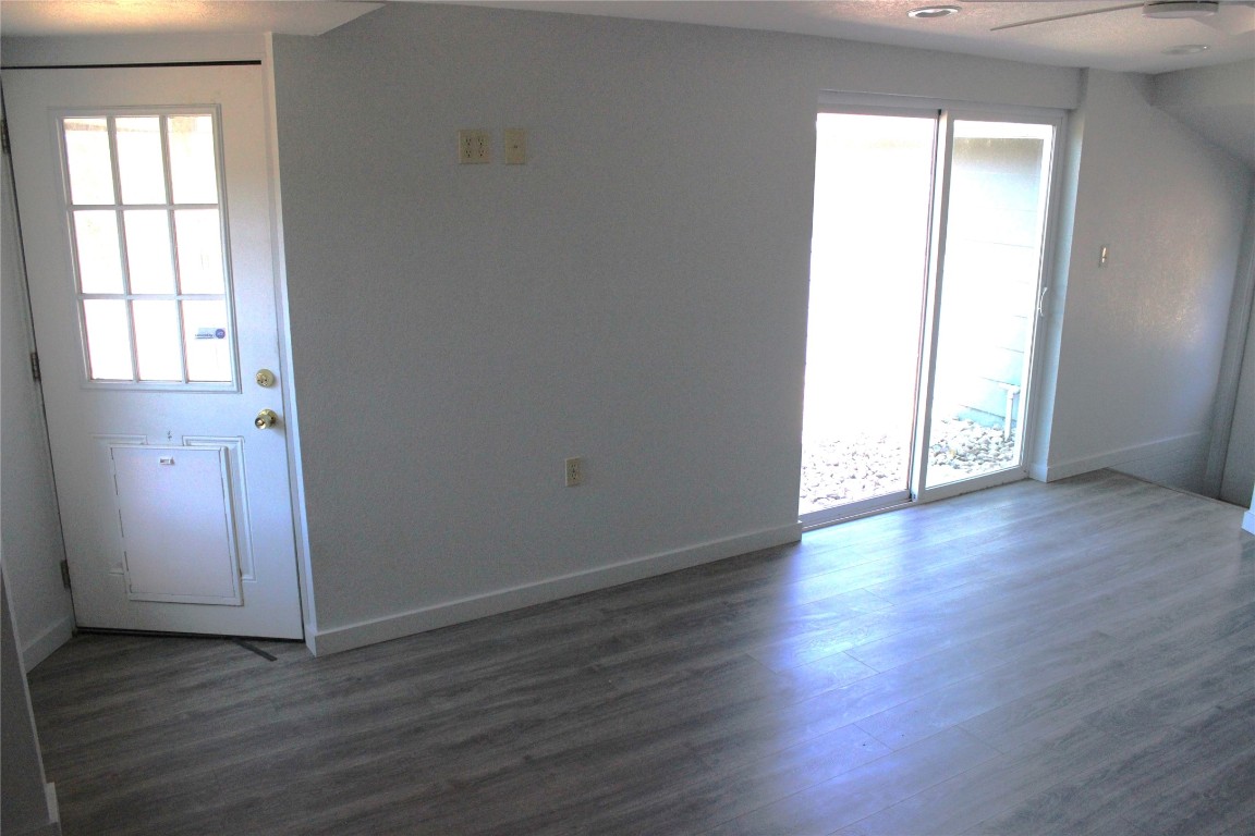 3300 Fritz Hughes Park Road Austin, TX 78732 - Photo 20 of 25 an empty room with wooden floor and windows