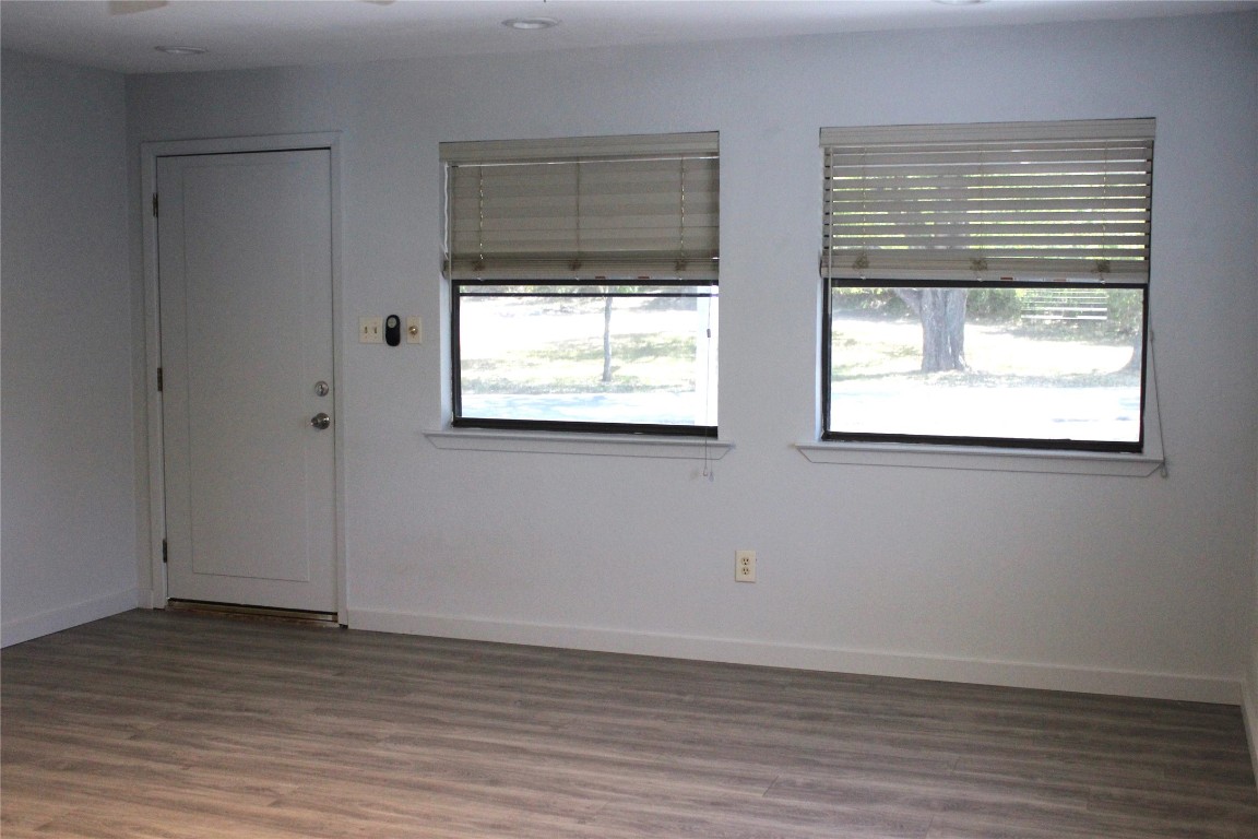 3300 Fritz Hughes Park Road Austin, TX 78732 - Photo 3 of 25 an empty room with wooden floor and windows