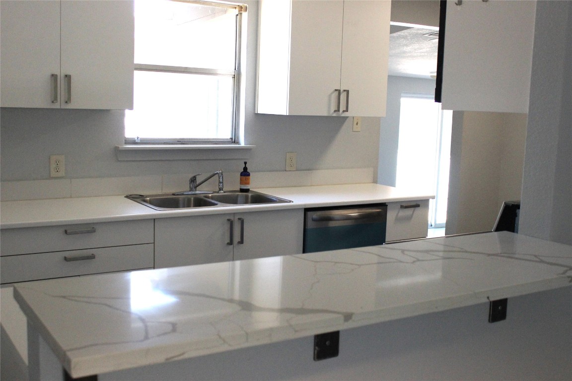 3300 Fritz Hughes Park Road Austin, TX 78732 - Photo 5 of 25 a kitchen with stainless steel appliances a sink and a window