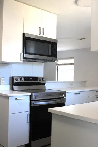 a kitchen with a sink and stainless steel appliances