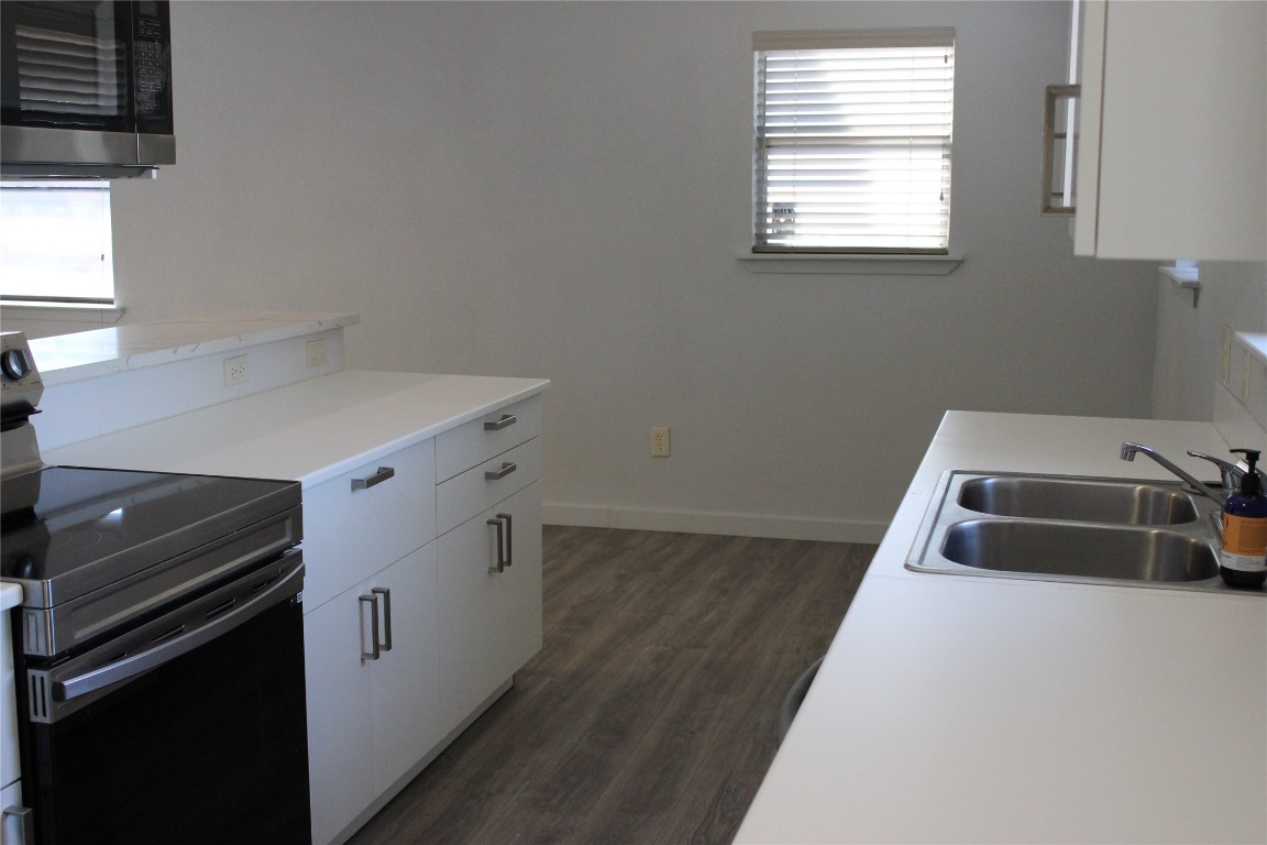 3300 Fritz Hughes Park Road Austin, TX 78732 - Photo 8 of 25 a kitchen that has a sink and a stove