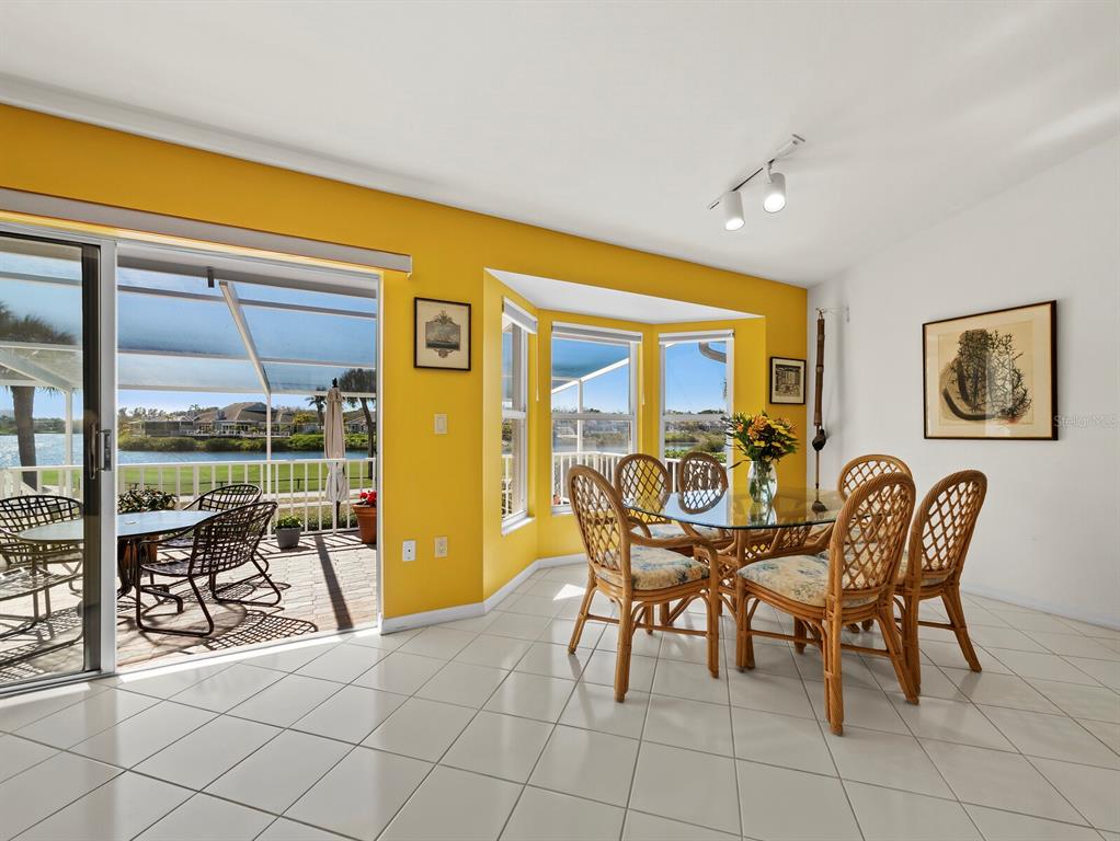 3459 Byron Lane Longboat Key, FL 34228 - Photo 11 of 40 a dining room with furniture and a floor to ceiling window