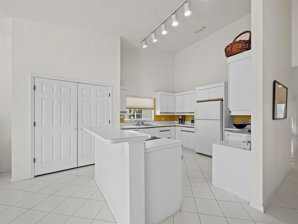 3459 Byron Lane Longboat Key, FL 34228 - Photo 13 of 40 a kitchen with white cabinets and appliances