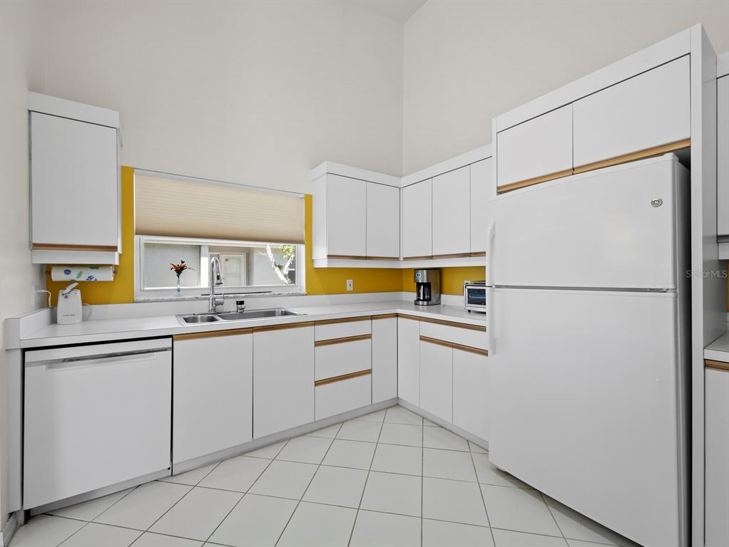 3459 Byron Lane Longboat Key, FL 34228 - Photo 14 of 40 a kitchen with appliances cabinets and a sink