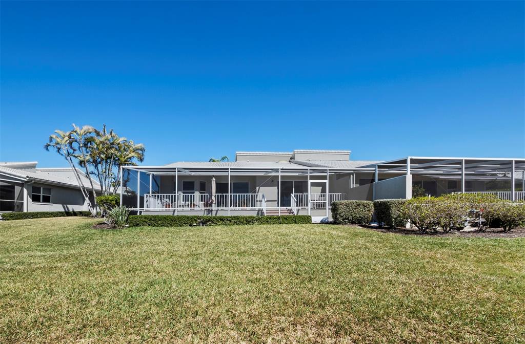 3459 Byron Lane Longboat Key, FL 34228 - Photo 22 of 40 a view of a house with a big yard and potted plants
