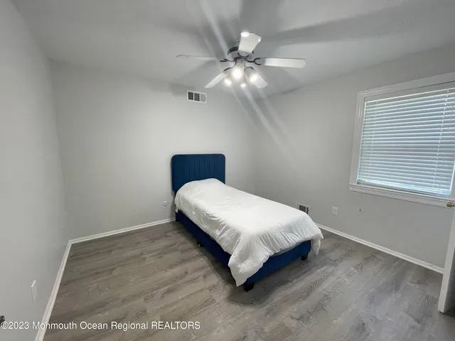 a bedroom with a bed and window