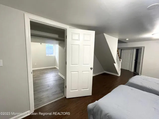 a view of a livingroom with wooden floor and stairs