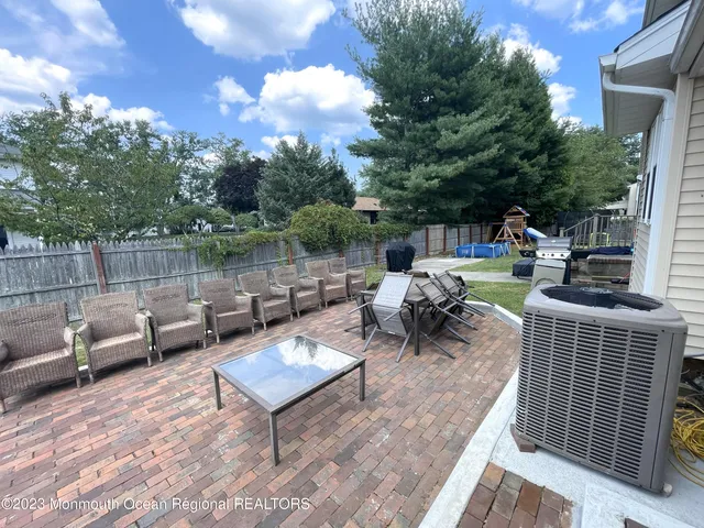 a view of a patio with couches chairs and a fire pit