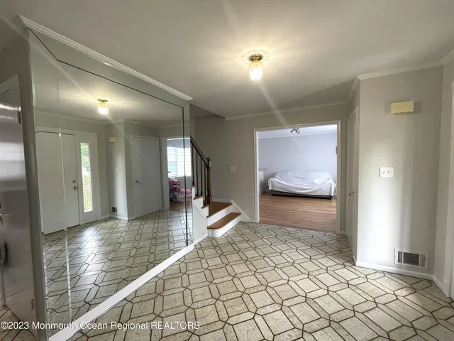 a hallway with a view of living room