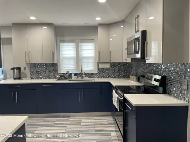 a kitchen with a sink cabinets and window