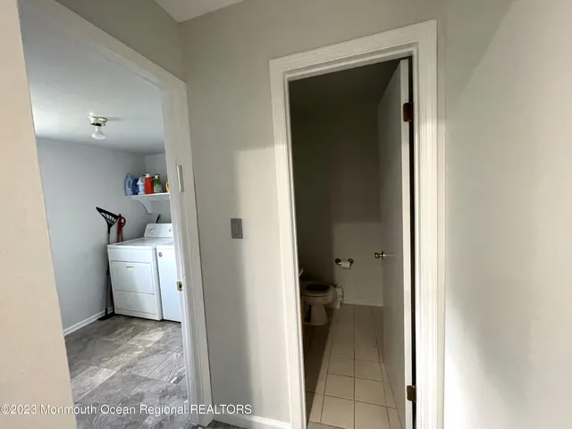 a view of a hallway with washer and dryer