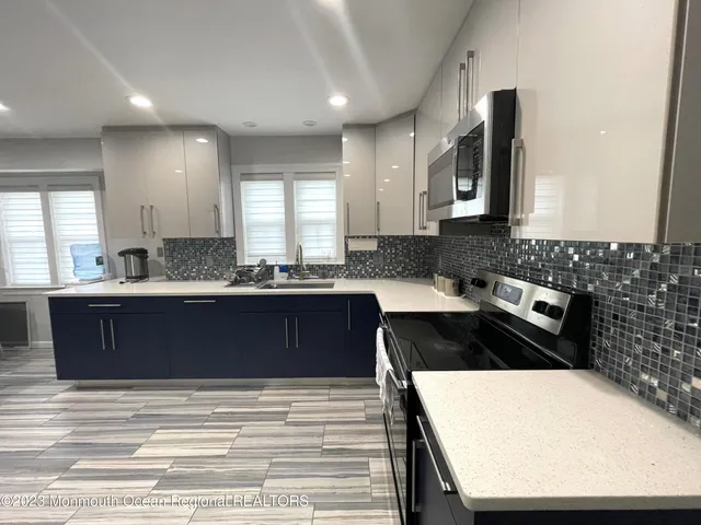 a kitchen with a refrigerator and a sink