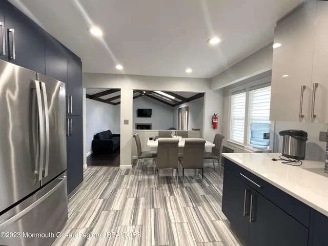 a kitchen with sink refrigerator and cabinets