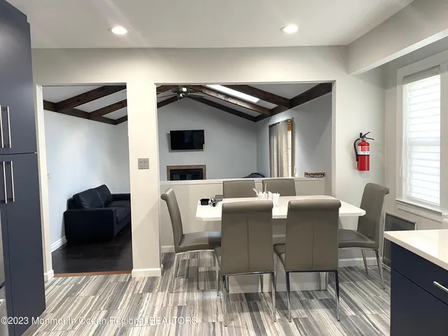 a dinning room with furniture and window