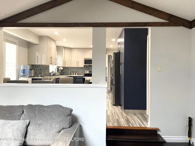 a kitchen with stainless steel appliances granite countertop a refrigerator and a stove