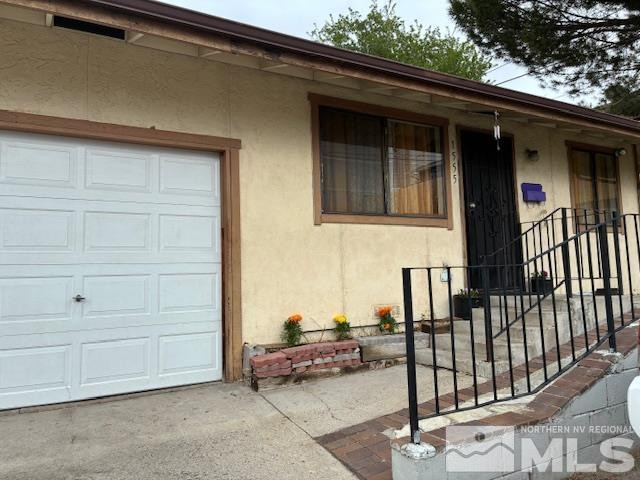 1545 Stardust Street, Unit 1545; 1555 Reno, NV 89503 - Photo 3 of 19 a view of a house with a garage