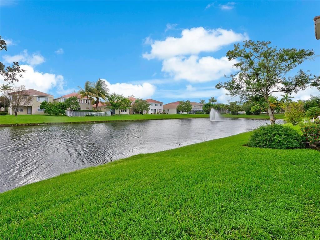 3075 Laurel Ridge Circle Riviera Beach, FL 33404 - Photo 8 of 12 a view of a lake with houses in the back