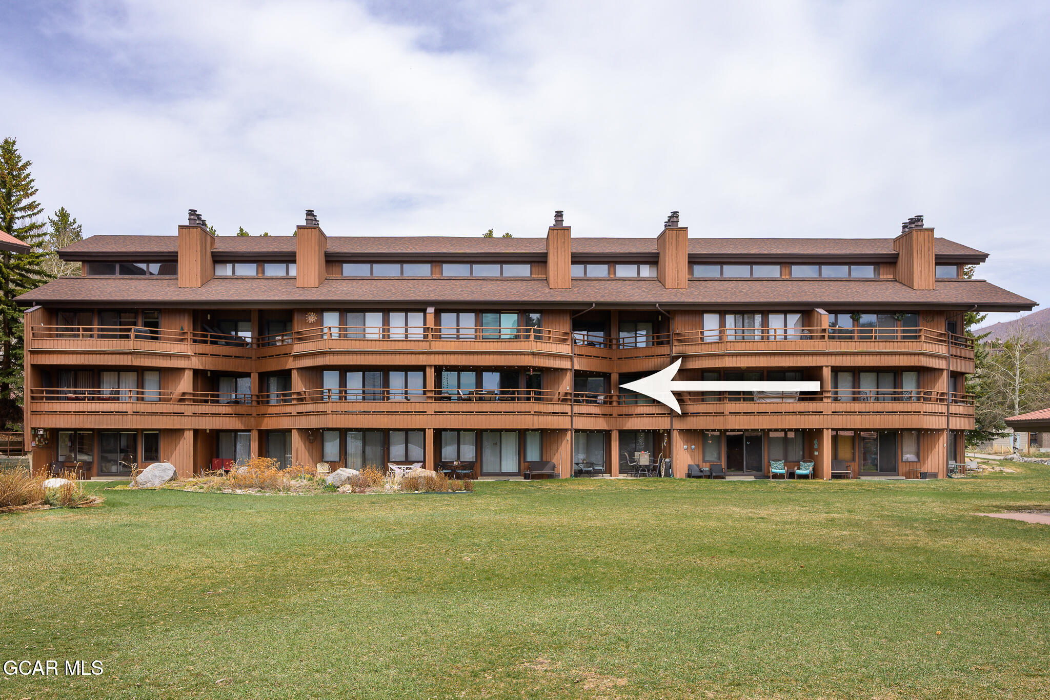 605 Lake Front Road, Unit W8 Grand Lake, CO 80447 - Photo 25 of 28 a view of a large building with a big yard and large trees