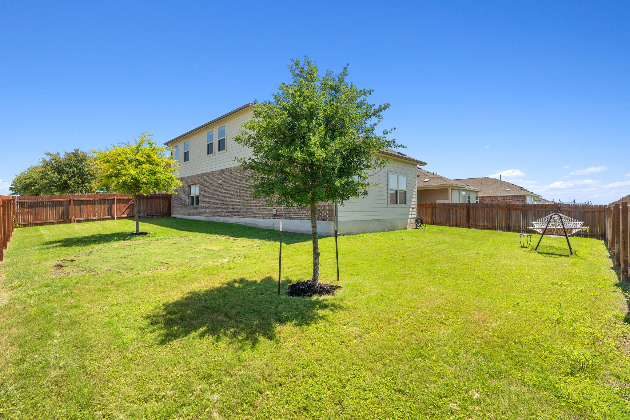 3101 Fresh Spring Road Pflugerville, TX 78660 - Photo 28 of 39 Spacious backyard featuring a manicured lawn, full privacy fencing, and trees offering shade now and in the future.