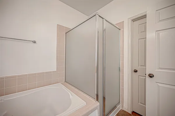 a bathroom with a bathtub and a shower