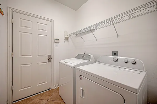 a view of storage and utility room with washer and dryer
